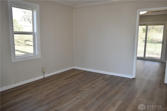 spare room featuring dark hardwood / wood-style floors