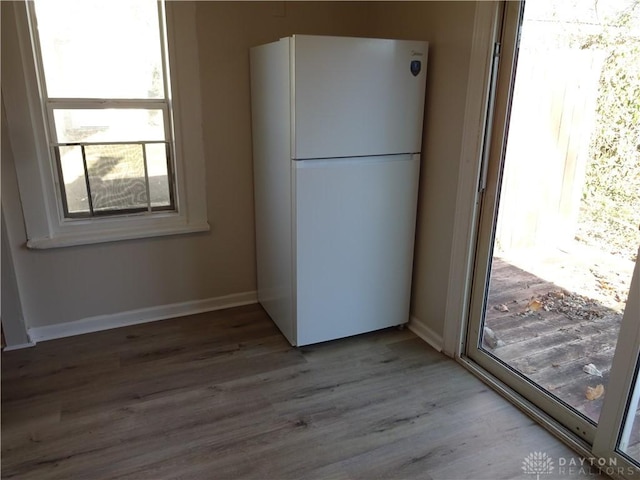 kitchen with white refrigerator and hardwood / wood-style flooring