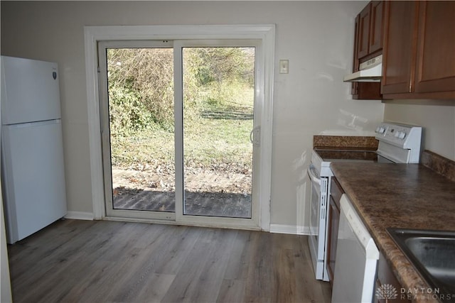 kitchen with white appliances, light hardwood / wood-style flooring, and sink