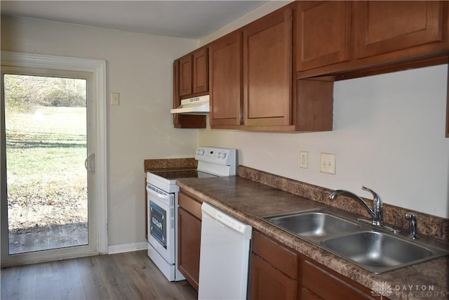 kitchen featuring sink, white dishwasher, light wood-type flooring, and range