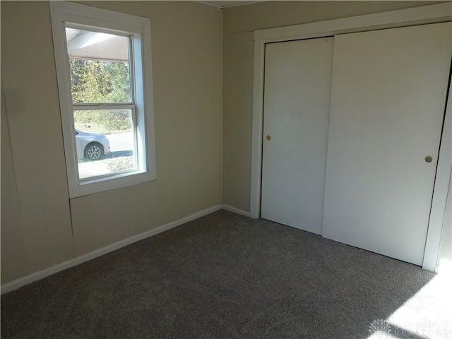 unfurnished bedroom with a closet and carpet