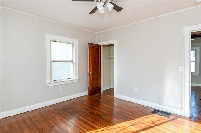 unfurnished room featuring ceiling fan and dark wood-type flooring