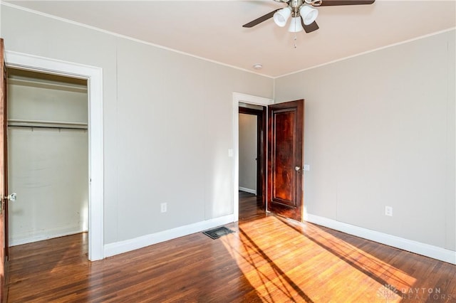 unfurnished bedroom with a closet, ceiling fan, and dark hardwood / wood-style floors