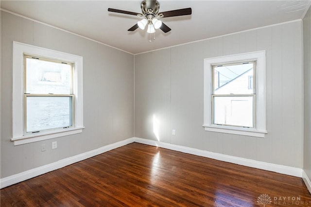 unfurnished room featuring a wealth of natural light, dark hardwood / wood-style flooring, and ceiling fan