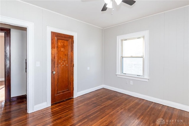 spare room featuring dark hardwood / wood-style flooring and ceiling fan