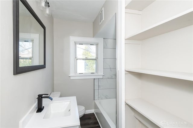 full bathroom featuring vanity, shower / bathtub combination, toilet, and wood-type flooring