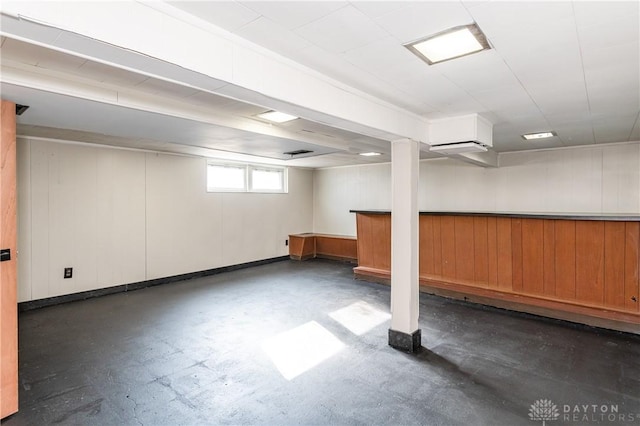 basement featuring wood walls