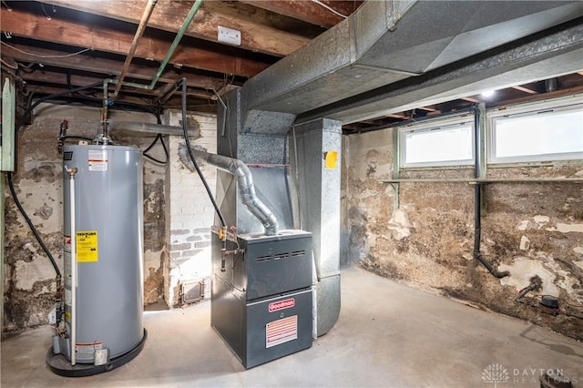 utility room featuring heating unit and water heater