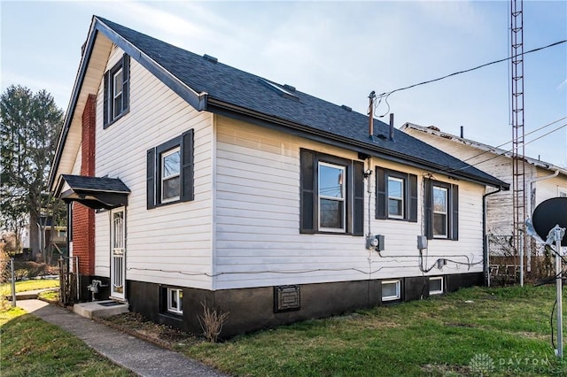 view of side of home featuring a lawn