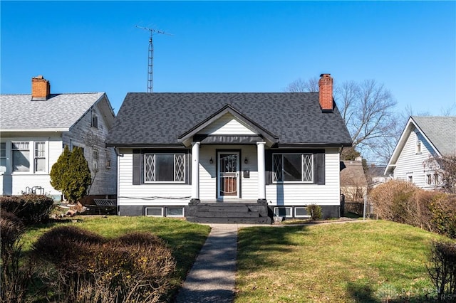 bungalow-style home with a front lawn