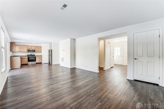 unfurnished living room featuring dark hardwood / wood-style floors