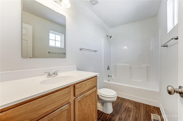 full bathroom featuring toilet, shower / tub combination, hardwood / wood-style flooring, and vanity