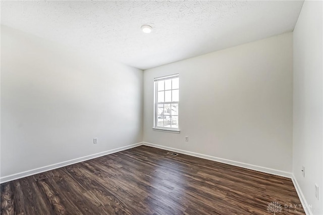 empty room with dark hardwood / wood-style floors