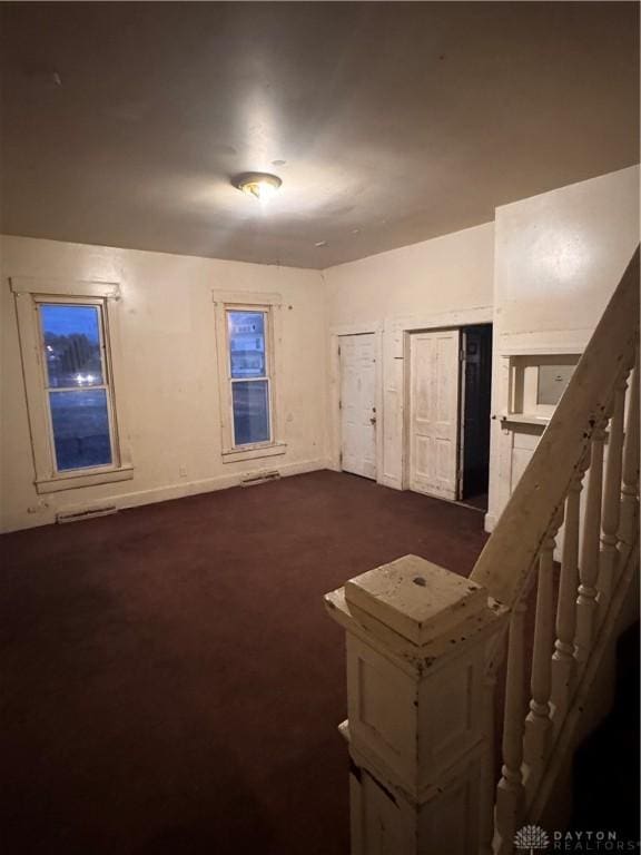 additional living space featuring dark colored carpet