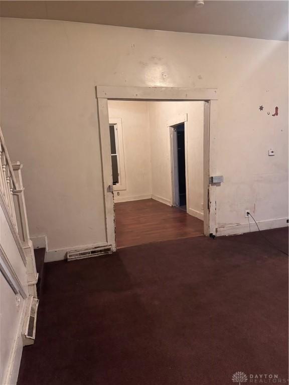 spare room featuring dark wood-type flooring