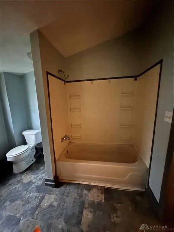 bathroom featuring shower / bathtub combination and toilet