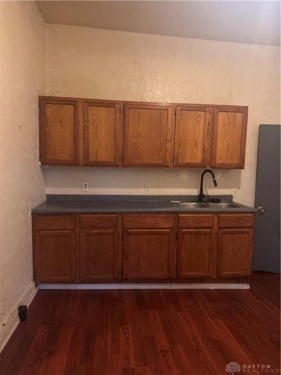 kitchen with dark hardwood / wood-style flooring and sink