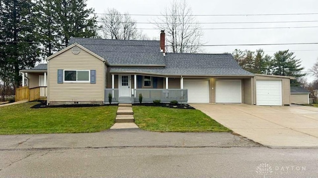 view of front facade with a garage, covered porch, and a front yard