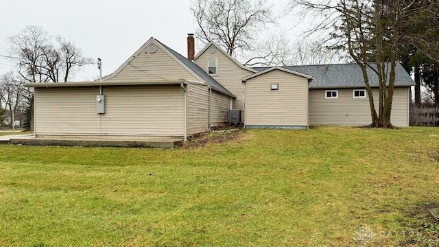 rear view of house with a yard