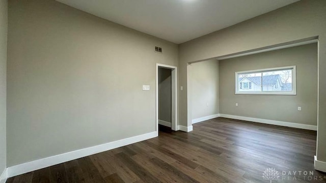 spare room featuring dark hardwood / wood-style flooring