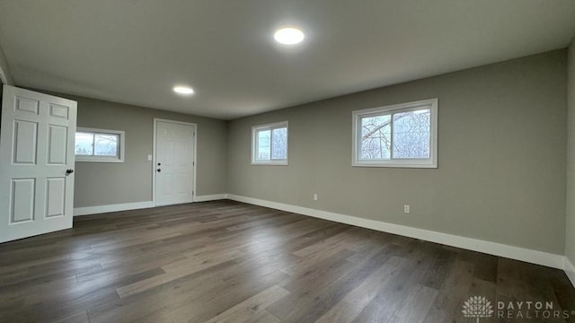 spare room featuring dark wood-type flooring