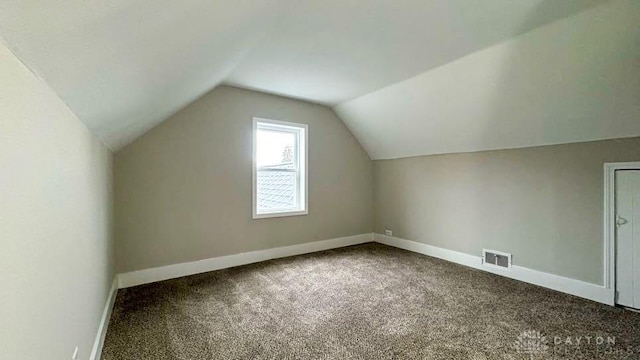 bonus room featuring carpet flooring and vaulted ceiling