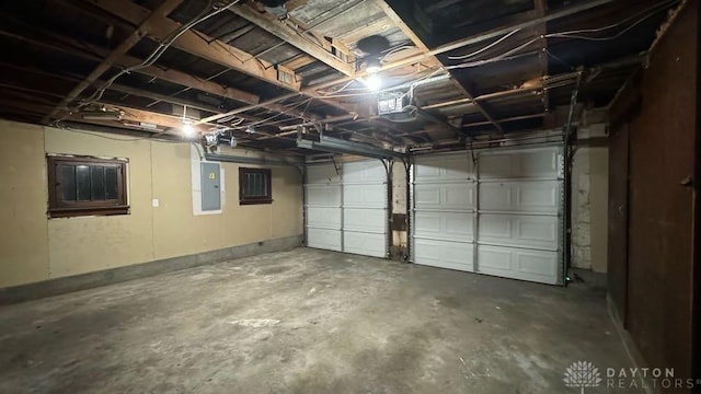 garage with electric panel and a garage door opener