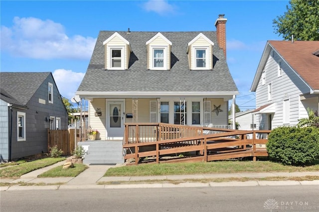 cape cod home featuring a porch