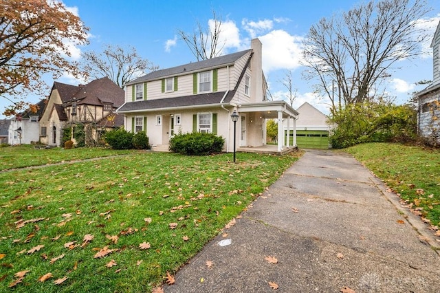 view of front facade with a front yard and a garage