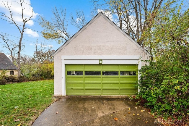 garage featuring a lawn