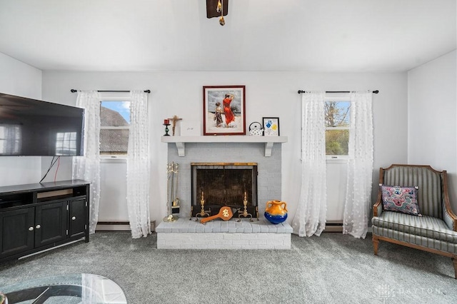 carpeted living room with a brick fireplace and a baseboard heating unit