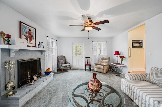 living room with carpet flooring, ceiling fan, and a fireplace