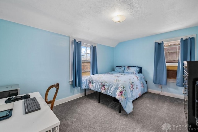 carpeted bedroom featuring a textured ceiling and vaulted ceiling