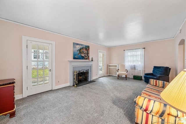 carpeted living room featuring ornamental molding