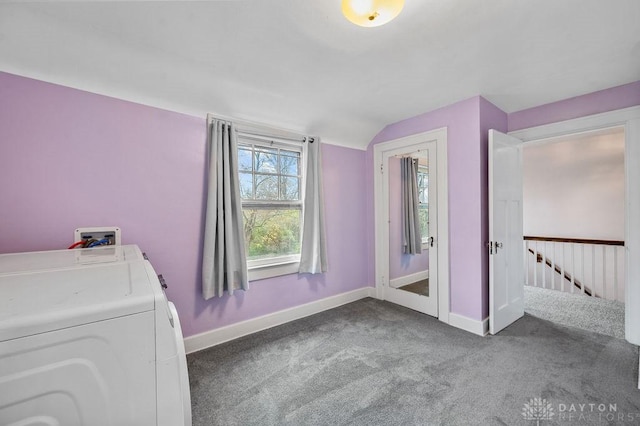 unfurnished bedroom with carpet, separate washer and dryer, and vaulted ceiling