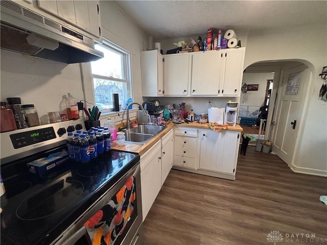 kitchen featuring white cabinetry, sink, stainless steel electric range oven, dark hardwood / wood-style floors, and a textured ceiling