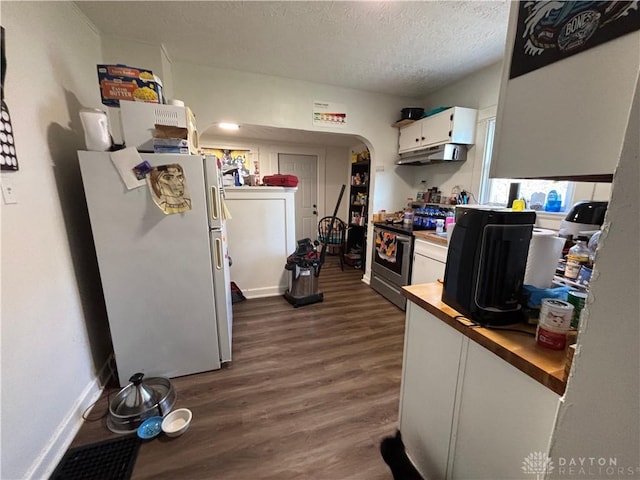 kitchen featuring a textured ceiling, electric range, white fridge, white cabinetry, and dark hardwood / wood-style floors