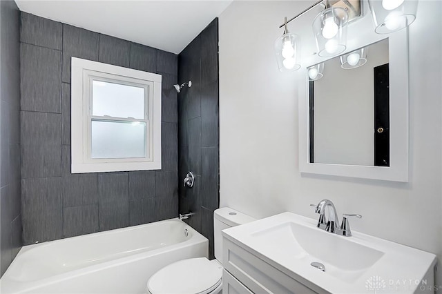 full bathroom featuring toilet, vanity, and tiled shower / bath