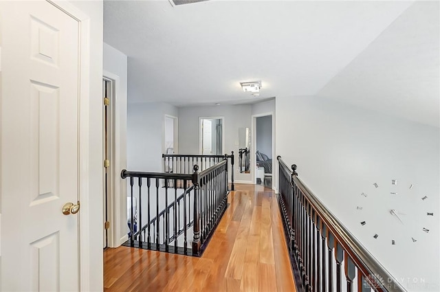 corridor with light hardwood / wood-style floors