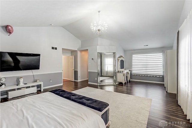 bedroom with lofted ceiling, dark hardwood / wood-style floors, and a chandelier