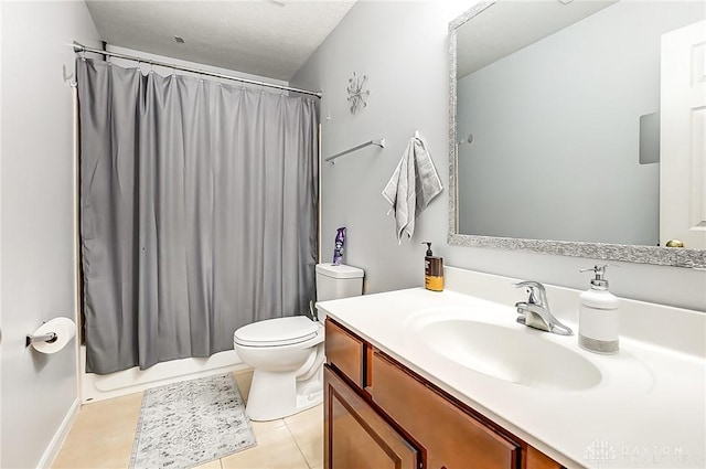 bathroom featuring vanity, tile patterned flooring, and toilet