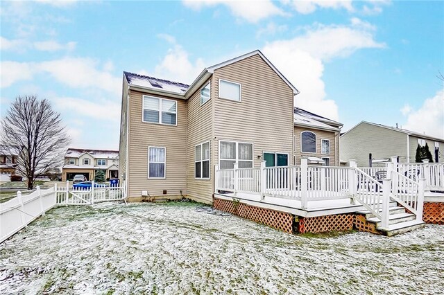 snow covered property with a deck