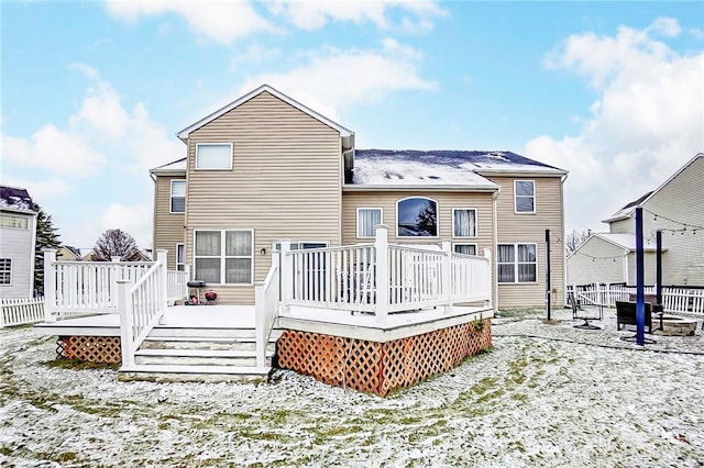 snow covered property featuring a wooden deck