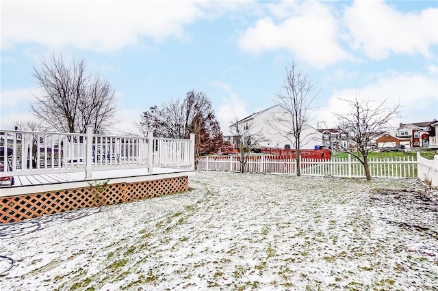 yard layered in snow featuring a deck