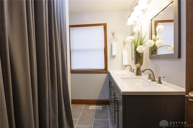 bathroom with tile patterned floors and vanity