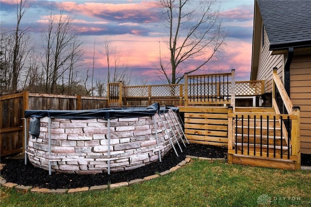 yard at dusk with a swimming pool side deck