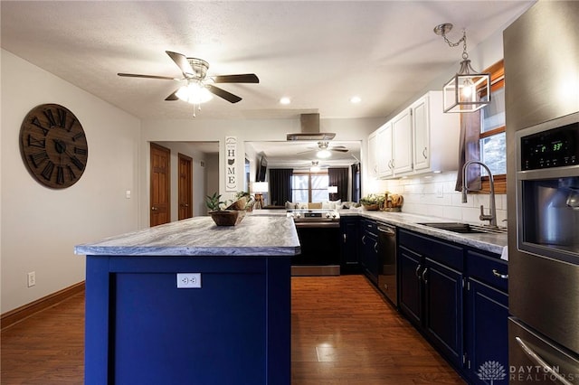 kitchen featuring backsplash, blue cabinets, sink, appliances with stainless steel finishes, and white cabinetry