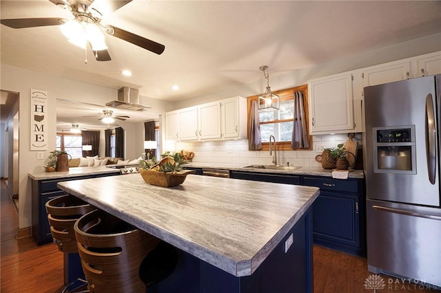 kitchen featuring white cabinetry, sink, stainless steel refrigerator with ice dispenser, and blue cabinets