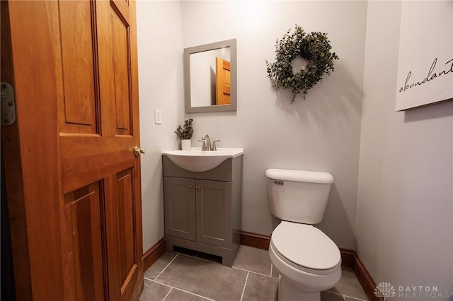 bathroom featuring tile patterned floors, vanity, and toilet