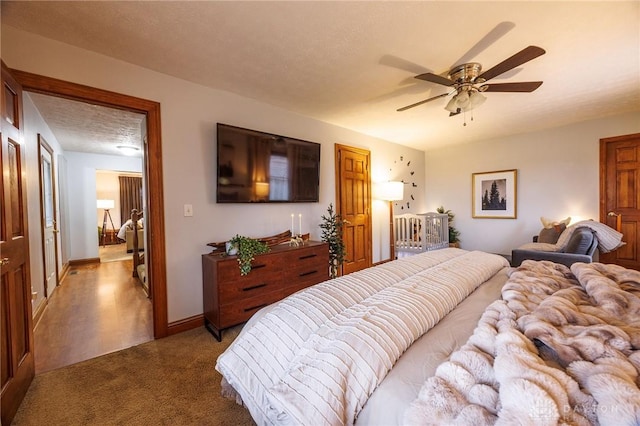 bedroom featuring ceiling fan, carpet, and a textured ceiling